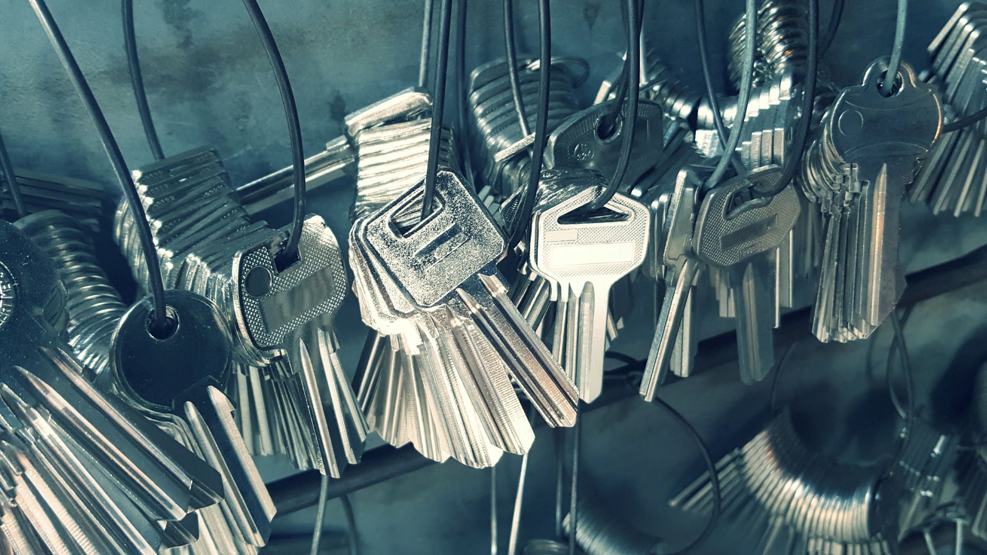 A bunch of keys are hanging from a string