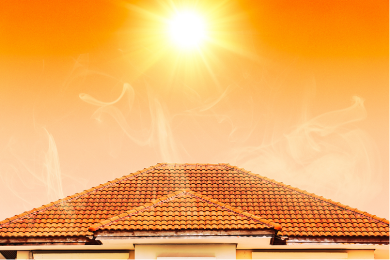 Rooftop with orange tiles under a bright sun in a hazy orange sky