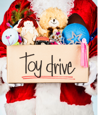 Holiday toys in a box labeled “Toy drive,” held by a person in a Santa suit