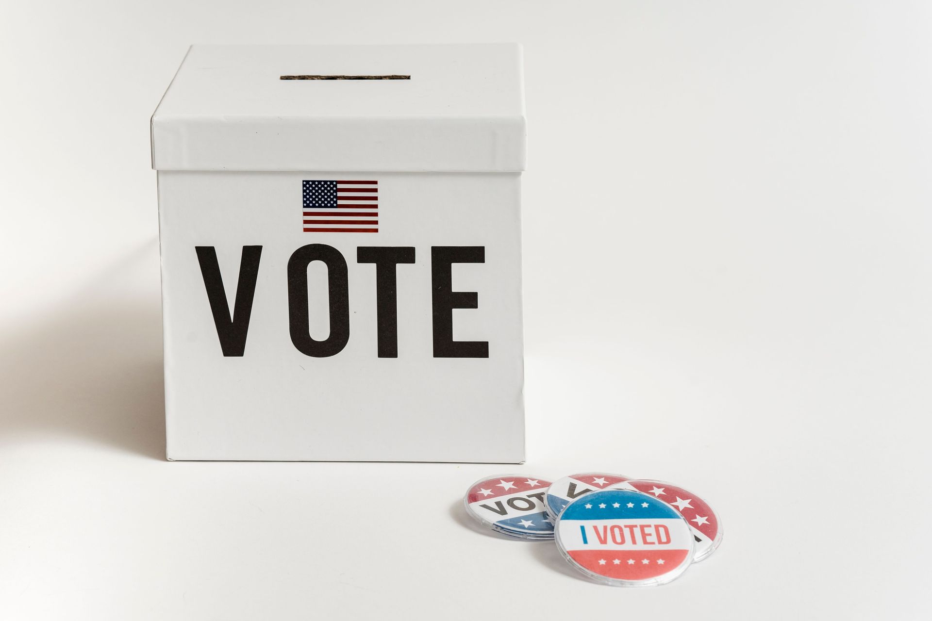 White ballot box marked VOTE for a condominium association board election
