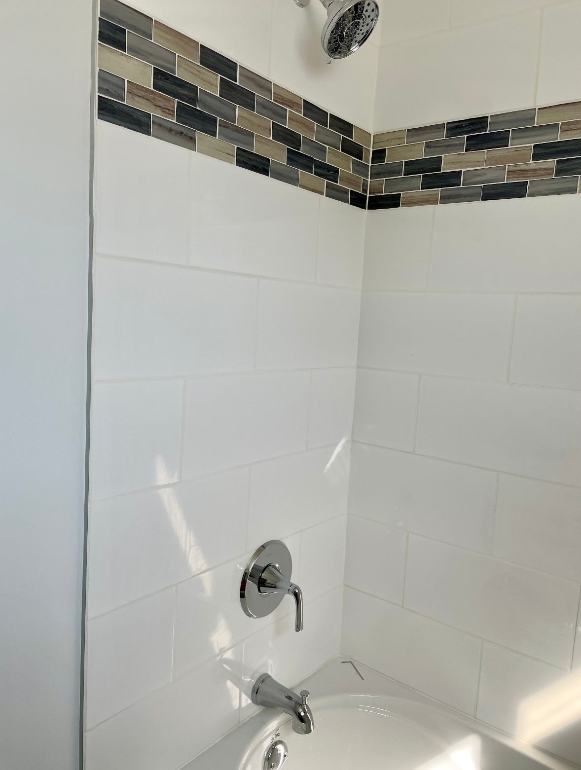 A bathroom with a bathtub and a shower head