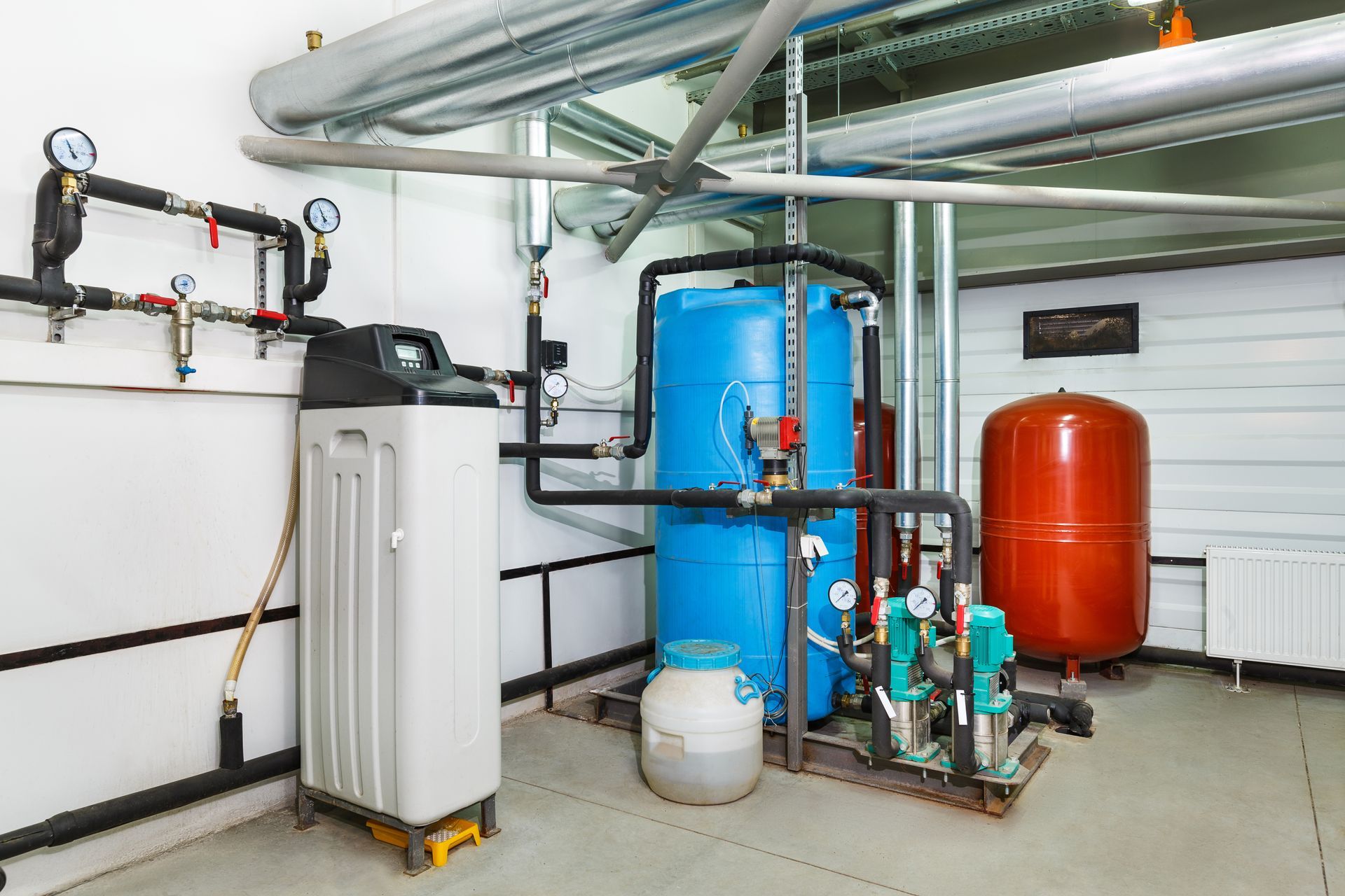 a room with a lot of pipes and tanks in it .