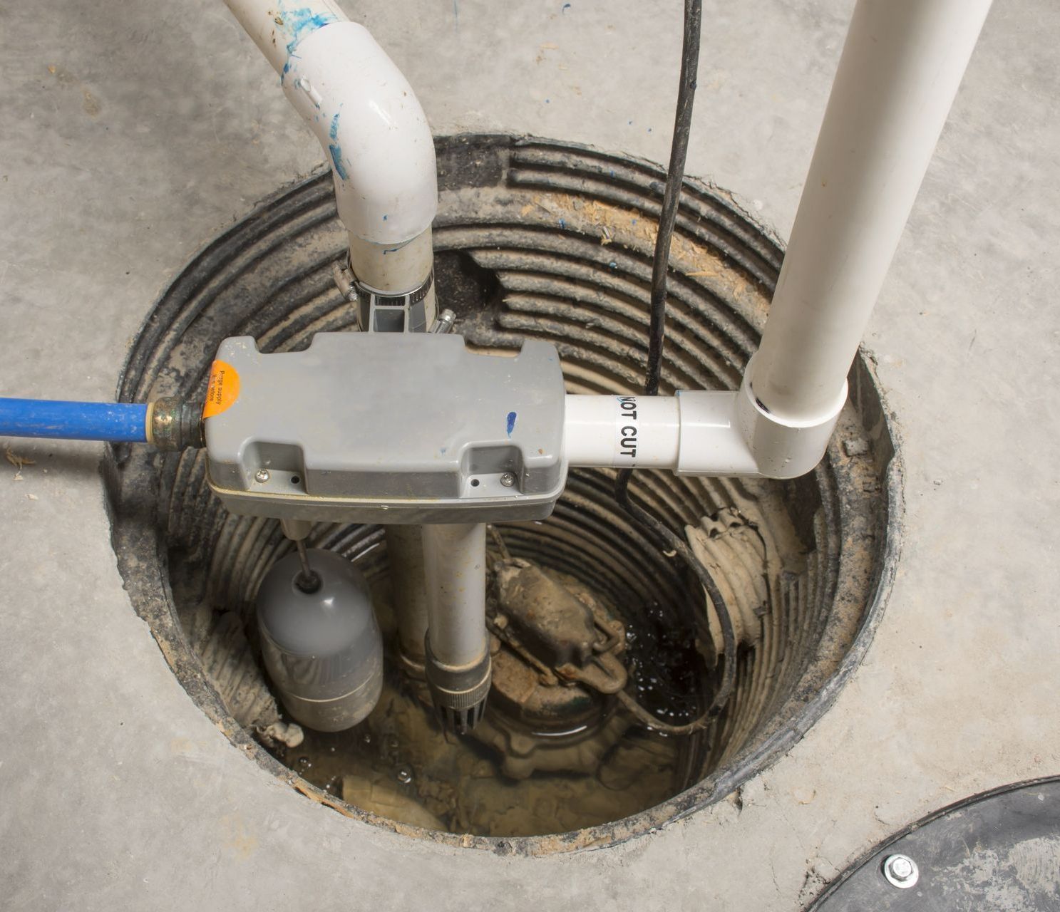 a close up of a sump pump in a basement .