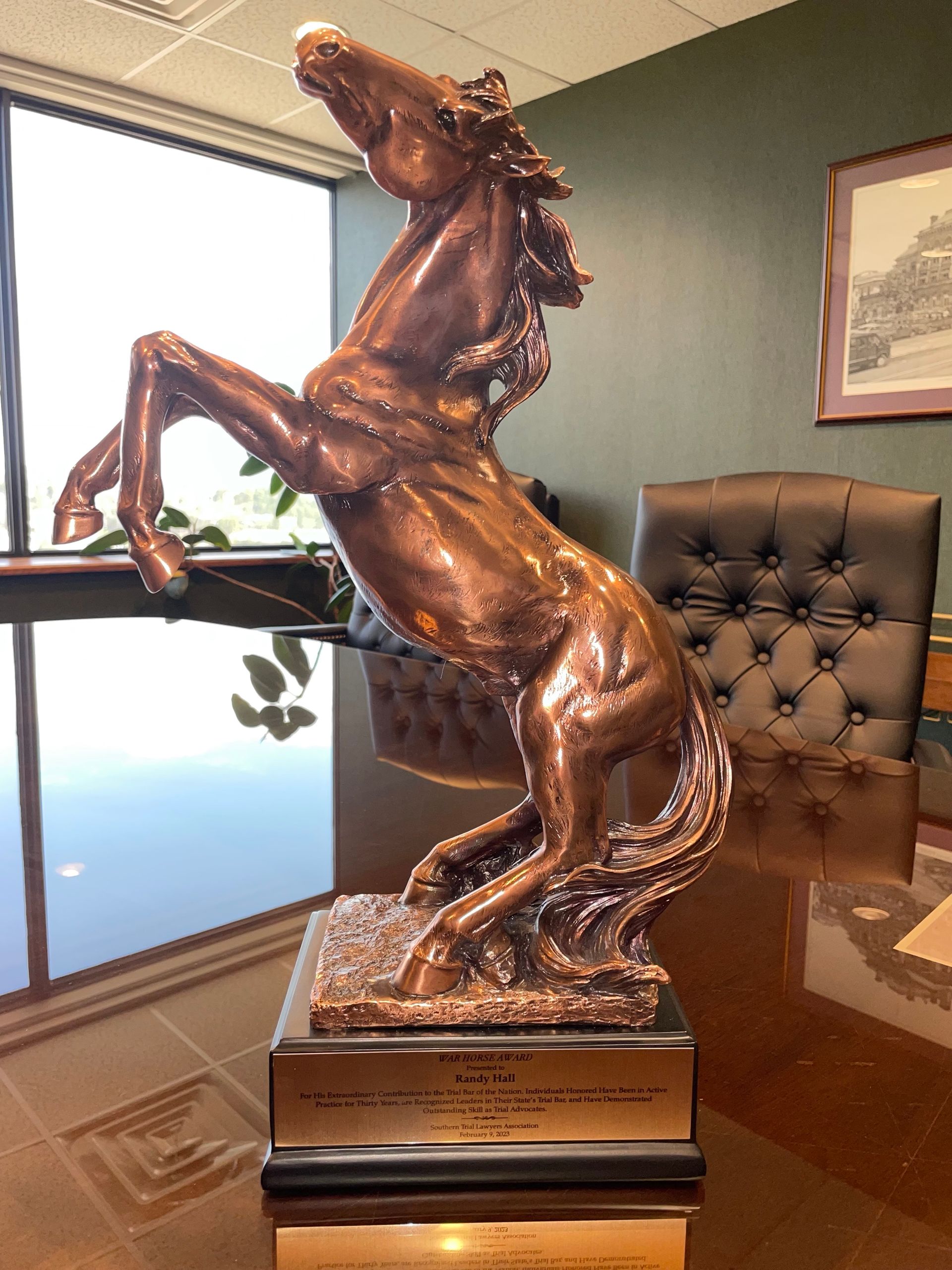 A statue of a horse standing on its hind legs on a table.