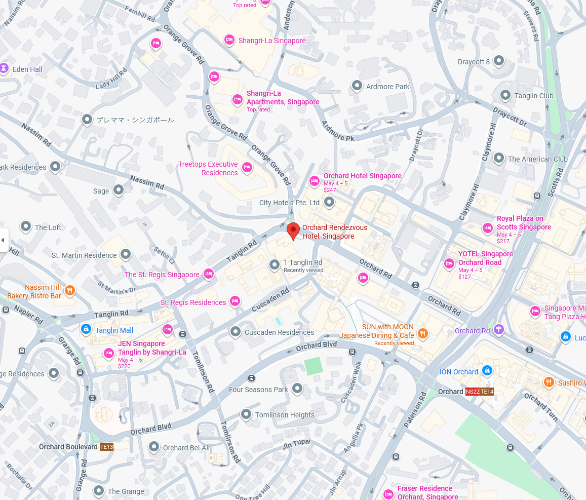 Map of a city center with roads, streets, and many pink and orange place labels.