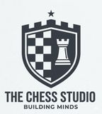The Chess Studio logo with a shield, chess pieces, and the text “THE CHESS STUDIO” and “BUILDING MINDS”