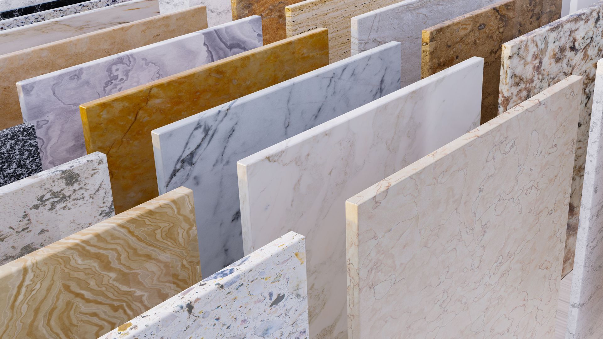Stacked decorative stone slabs in various colors and patterns, displayed upright in a showroom