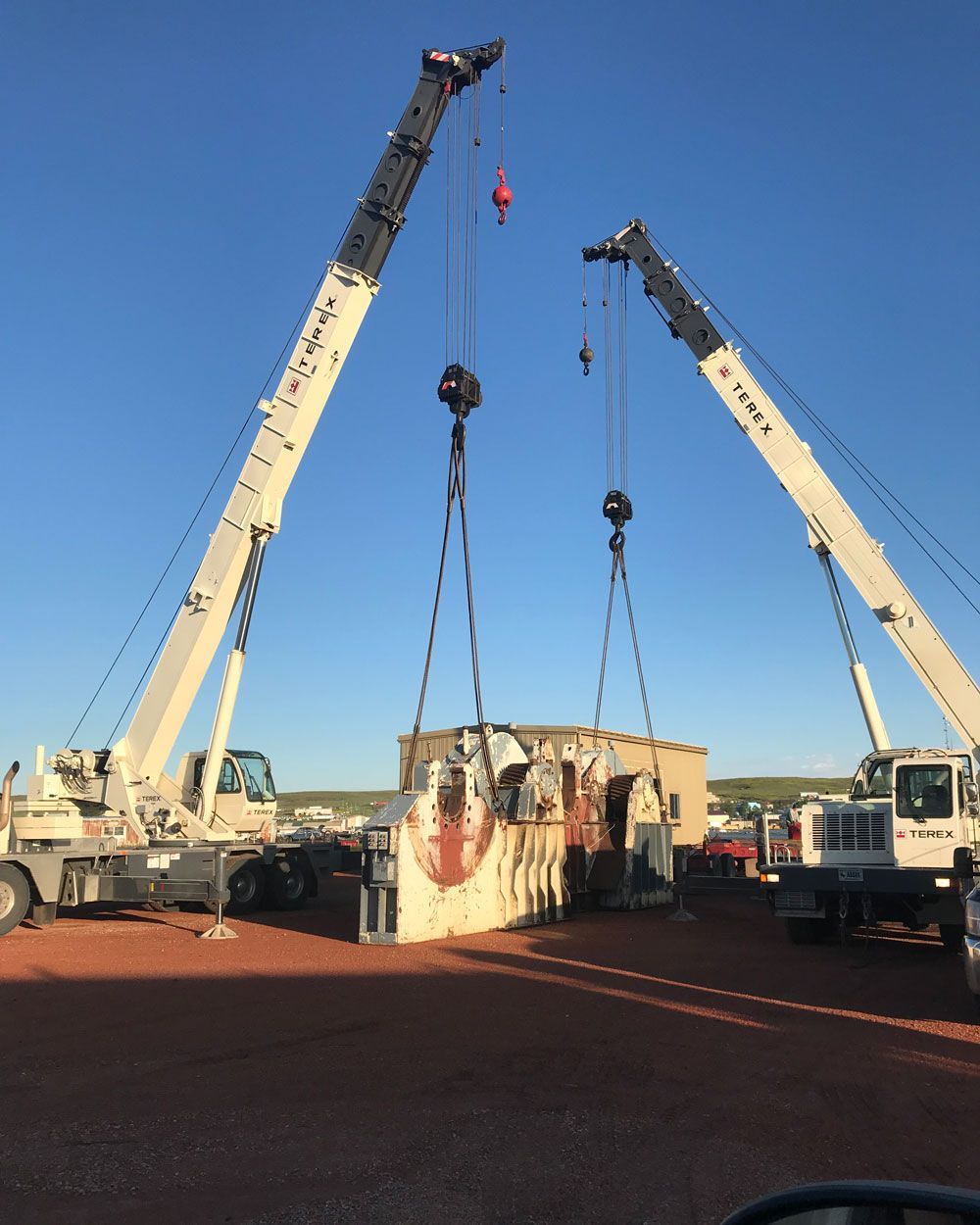 Crane Carrying Heavy Equipment — Gillette, WY — Black Hawk Crane & Rigging Inc