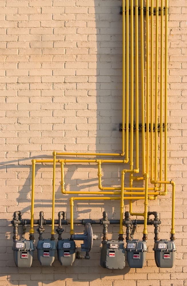 A Row Of Gas Meters On A Brick Wall — BAS Plumbing & Drainage In Forresters Beach, NSW