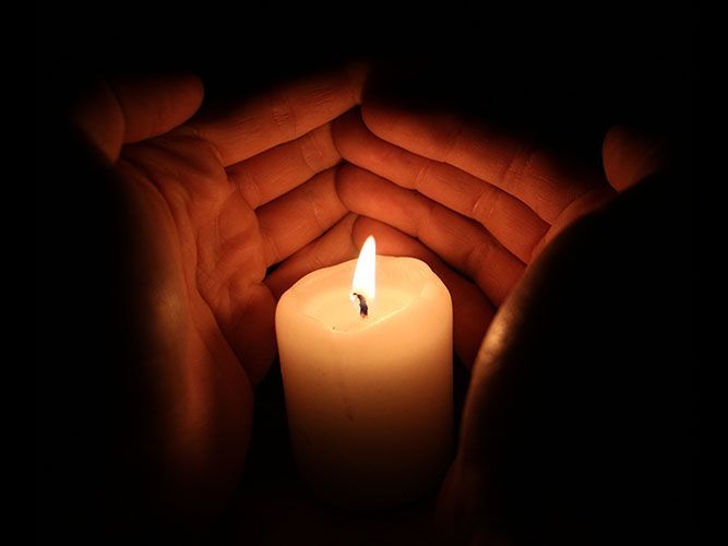 hands around a candle