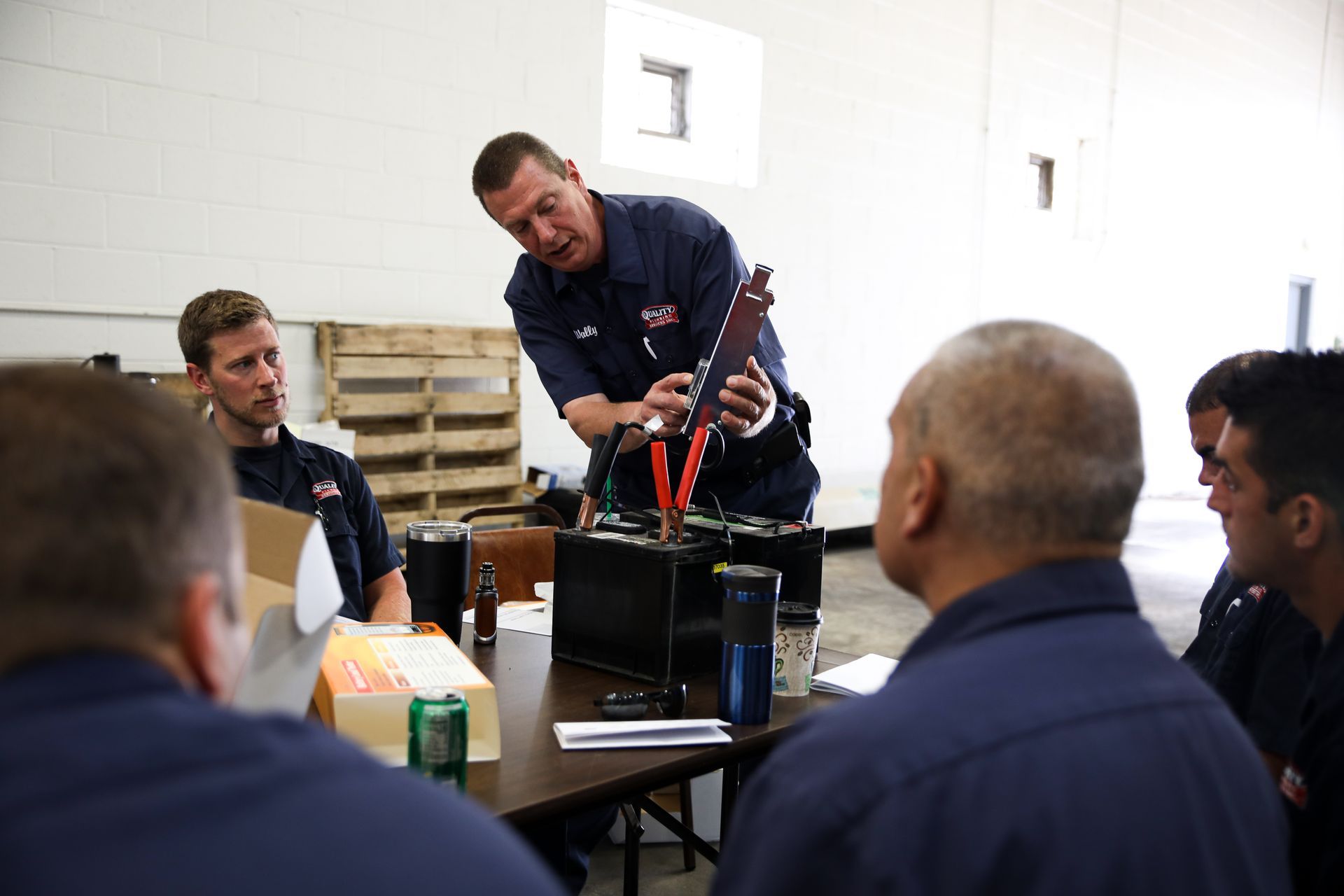 A man is giving a presentation to a group of plumbers.