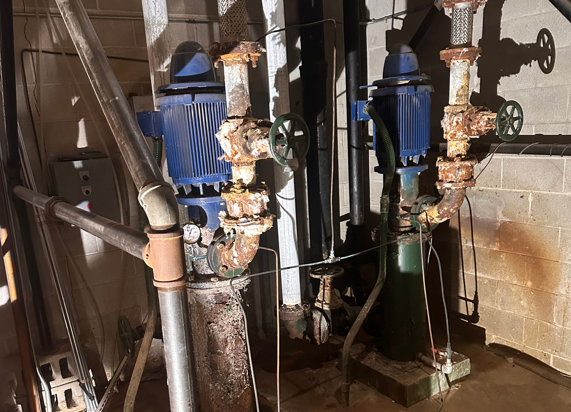 Original domestic water booster pump system after approximately 54 years of continuous service.