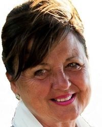 A close up of a woman 's face smiling on a white background.