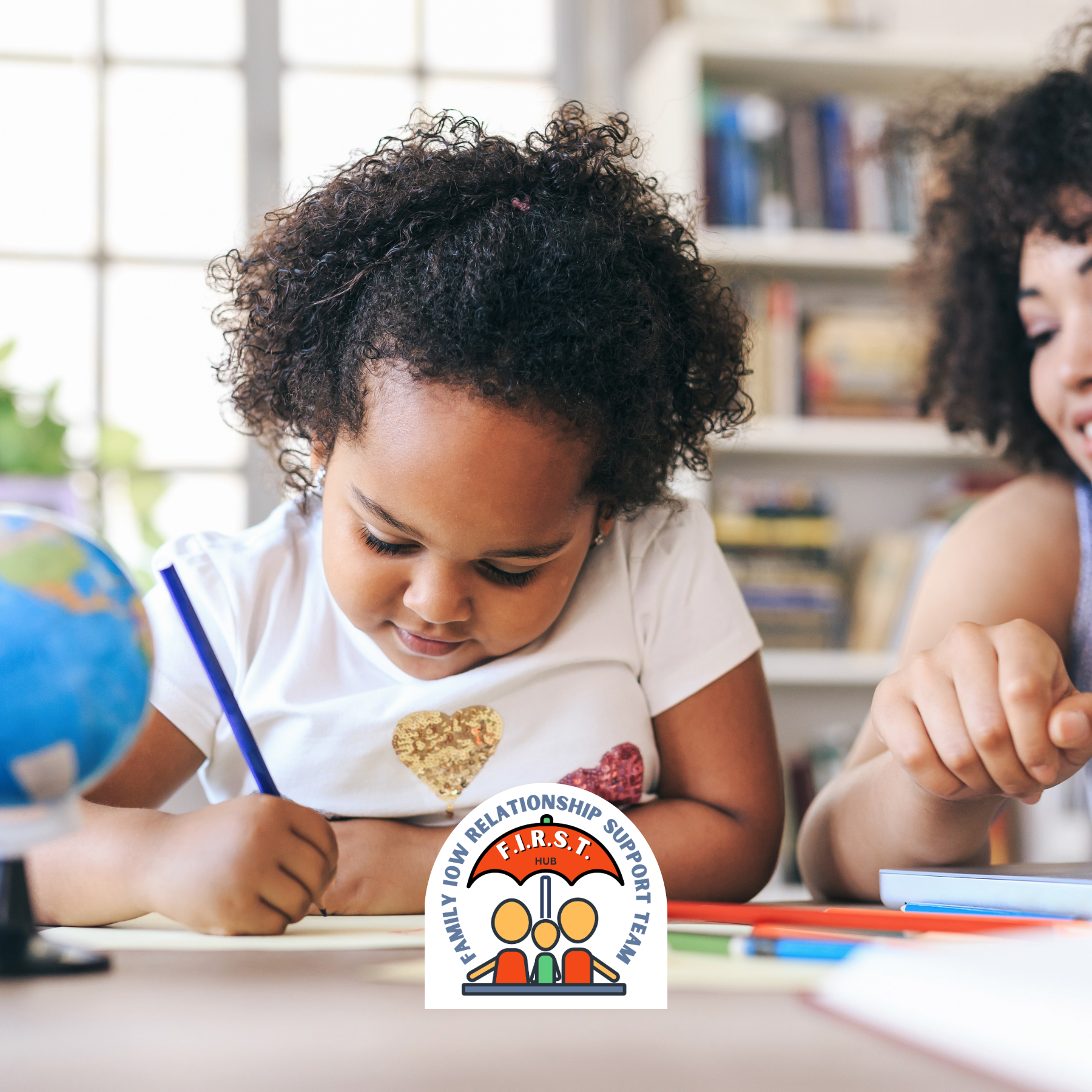 Child writing at a table in a bright classroom, with bookshelves and a globe in the background.