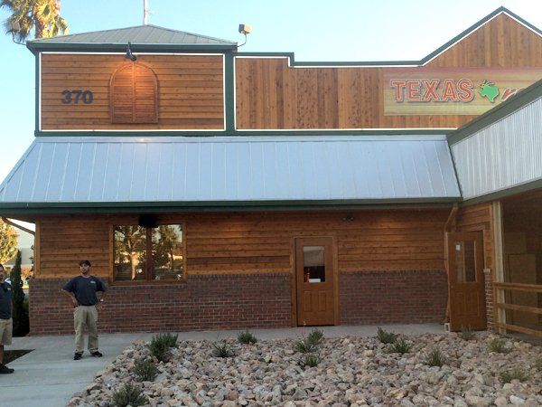 A man stands in front of a texas restaurant