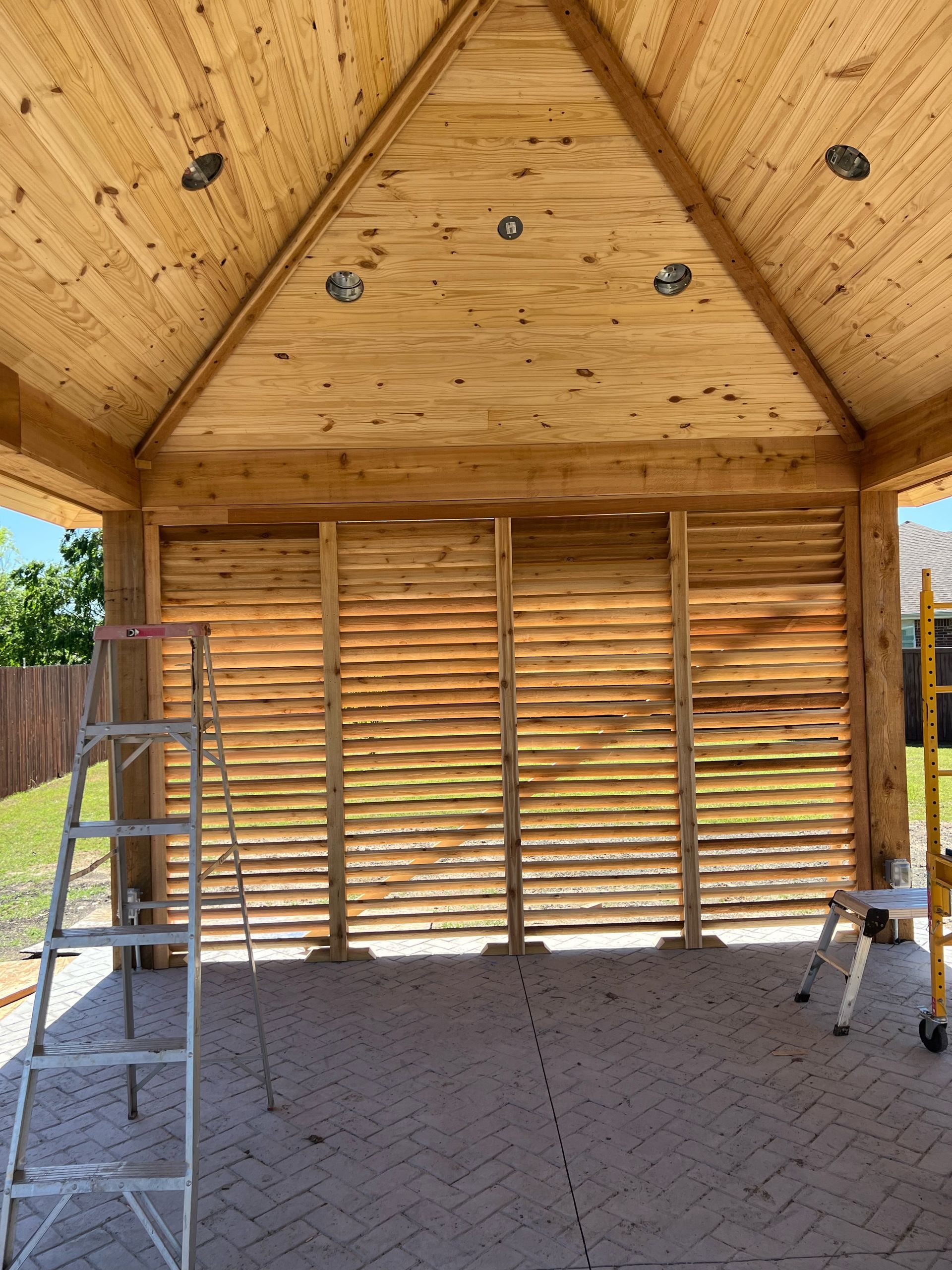 A ladder is sitting in the middle of a wooden building.
