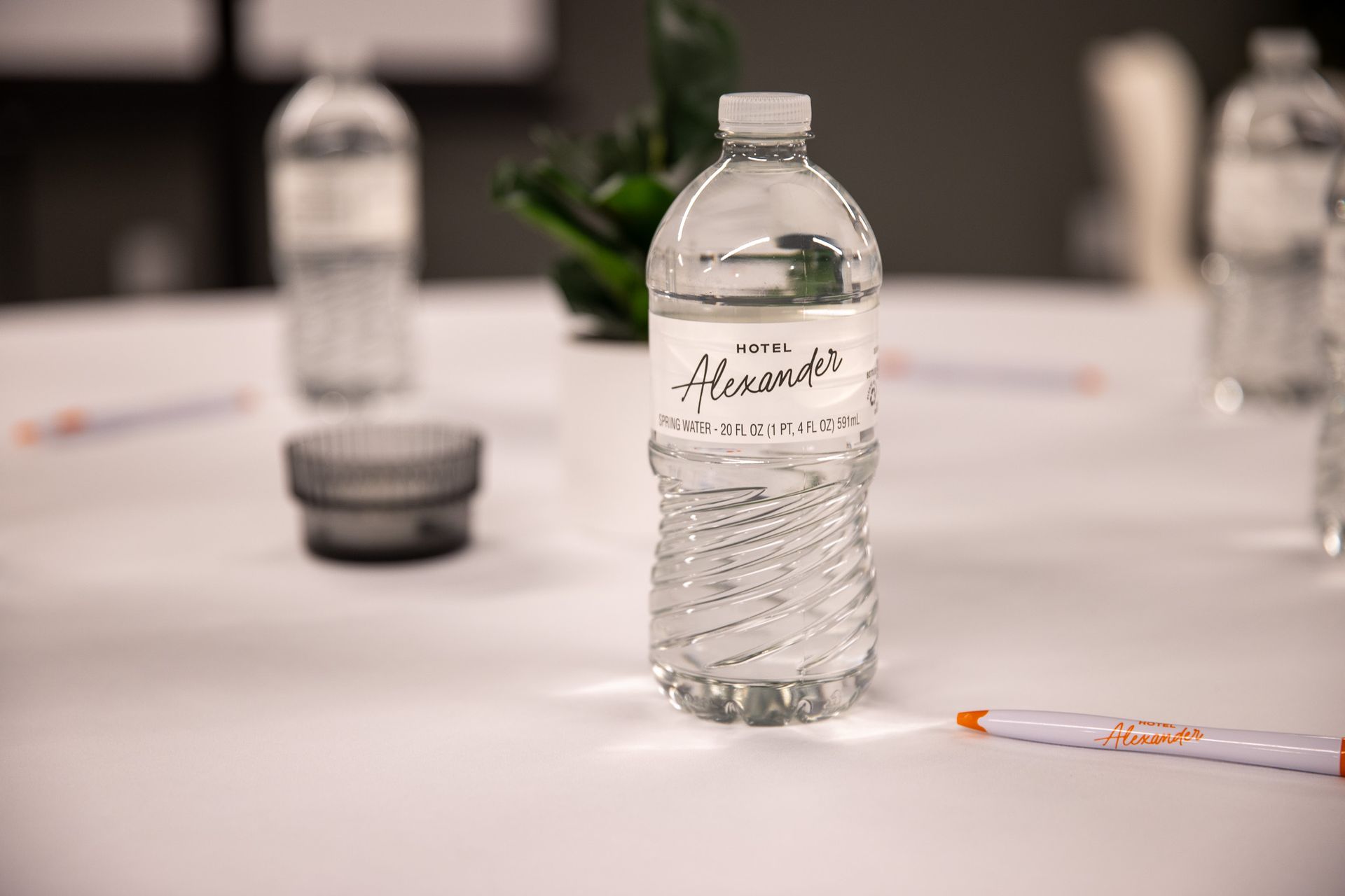 Clear bottled water on a table with a blurred conference room background