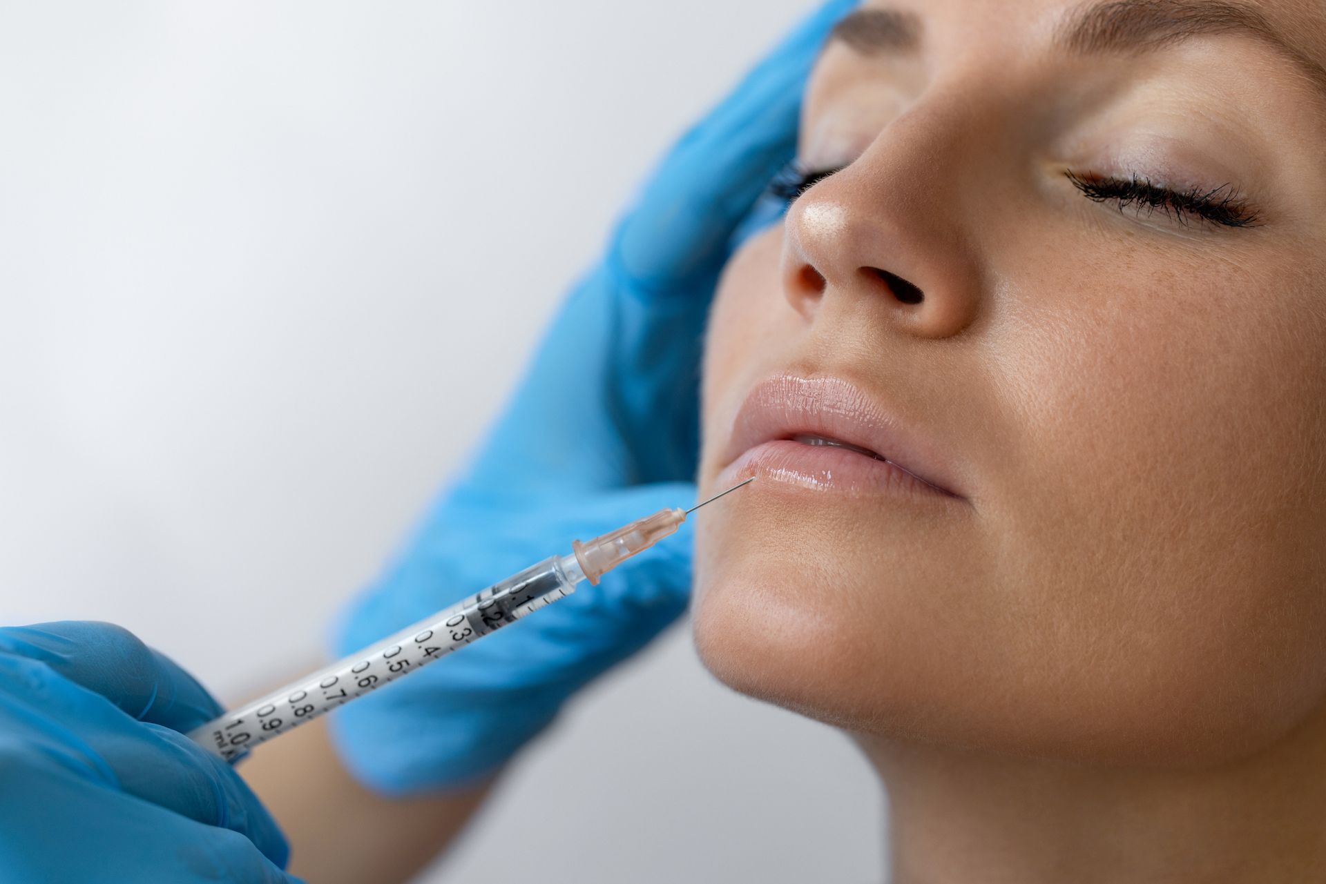 Female getting Botox injection into her face.