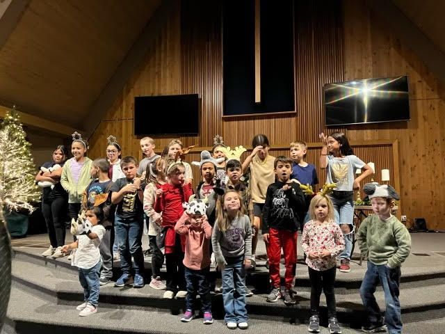 The children of FSKids gather on the sanctuary stage for a group photo.