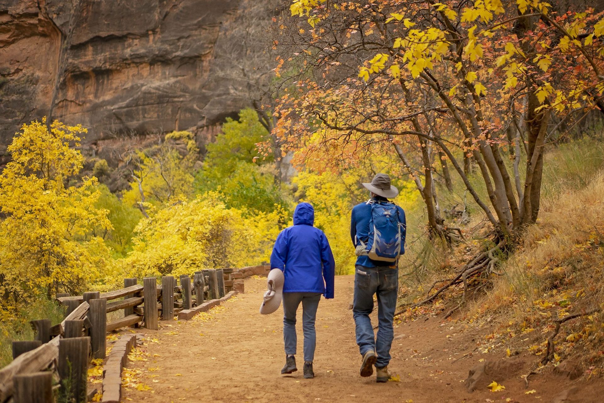 Hikers on the Riverside Walk in fall. This paved trail ends where the Narrows begin.
