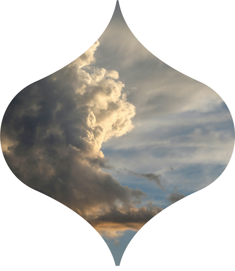 Red sunset over dark hills, framed in a diamond-shaped silhouette.