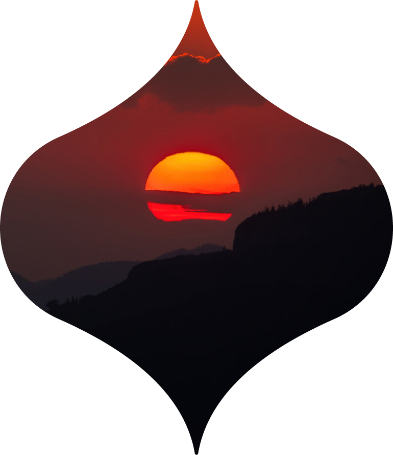 Red sunset over dark hills, framed in a diamond-shaped silhouette.