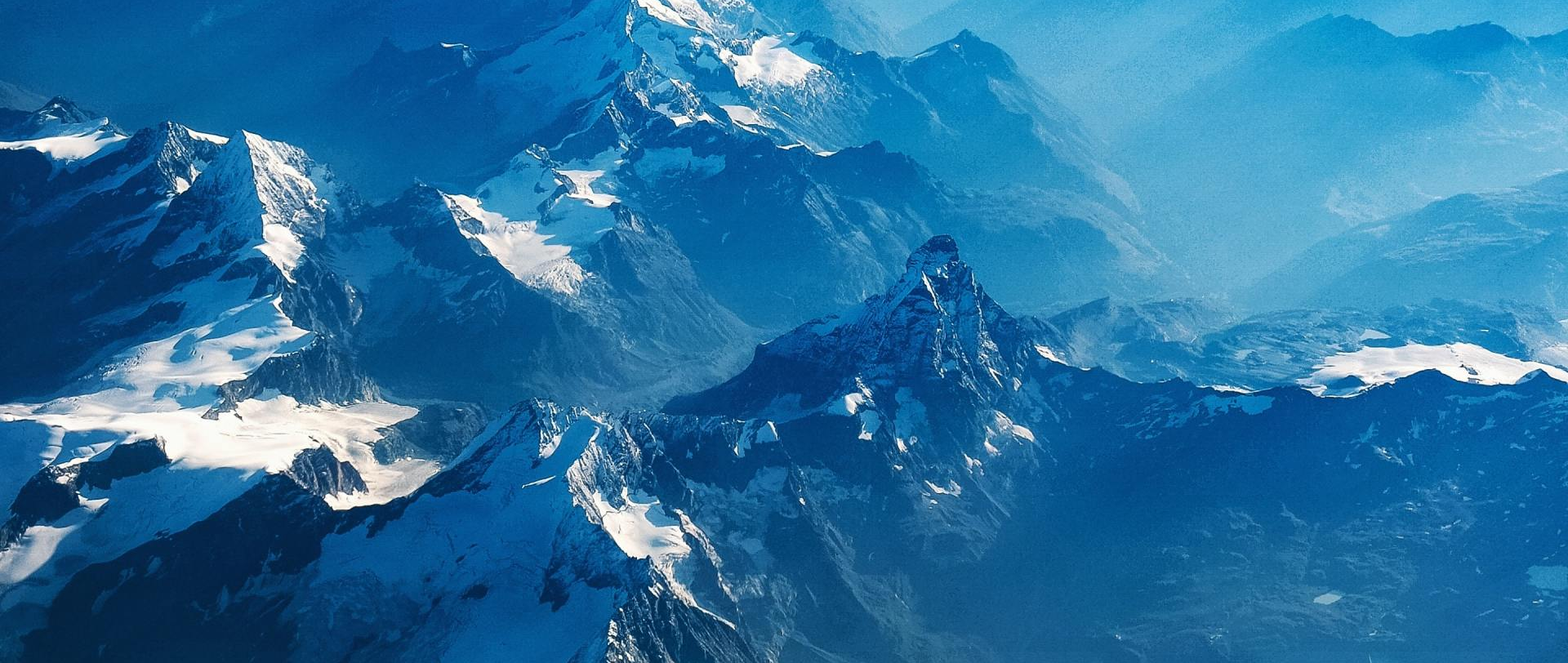 Snow-covered mountain peaks under a blue sky