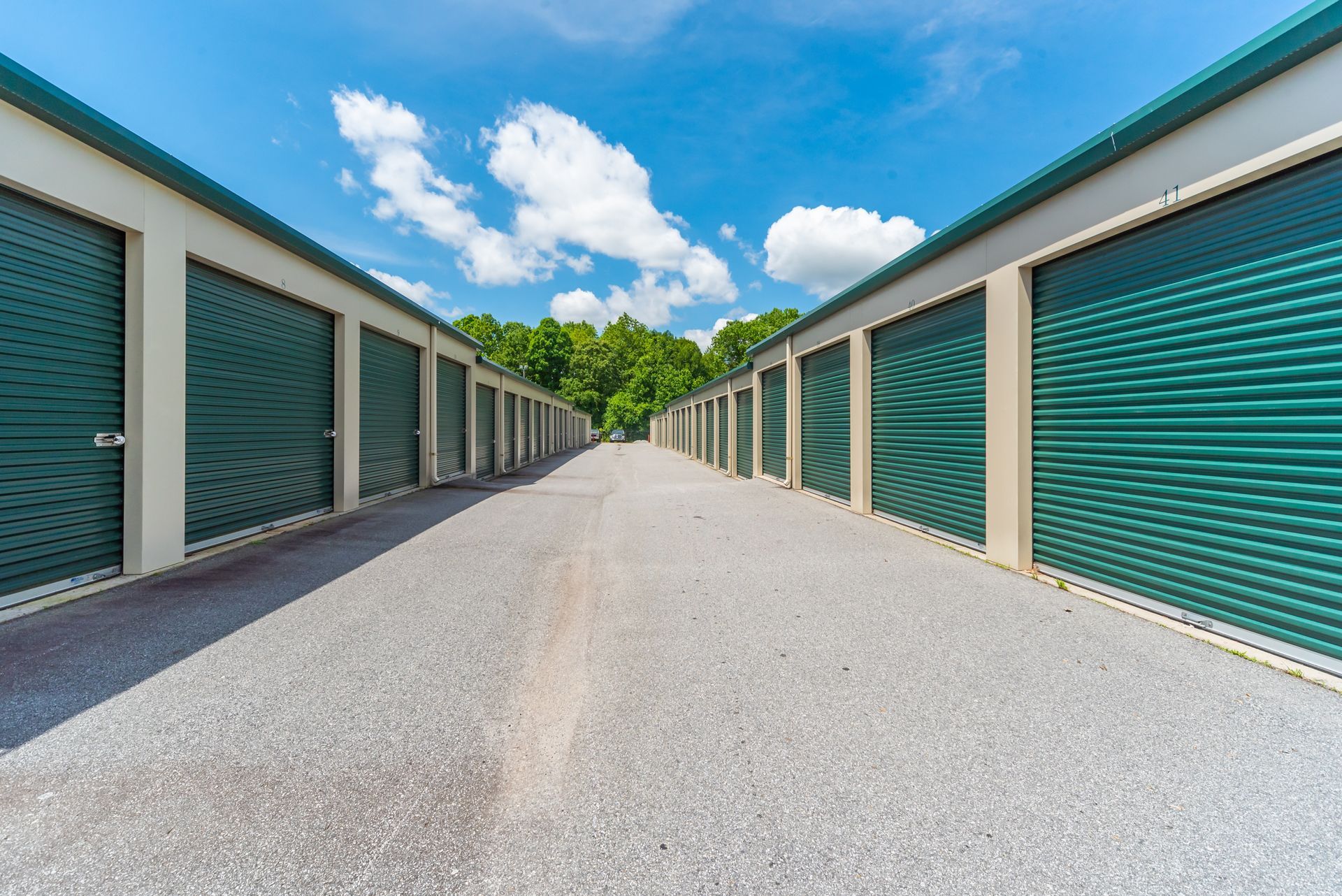 Rows of Green Storage Unit Doors Line a Gravel Path — Gympie Southside Mini Storage in Southside, QLD