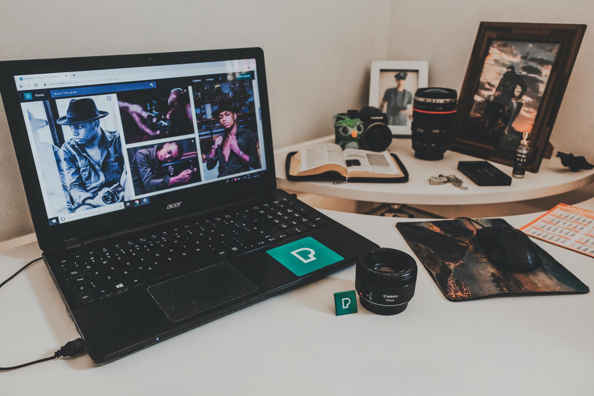 A laptop computer is sitting on a desk next to a mouse pad.