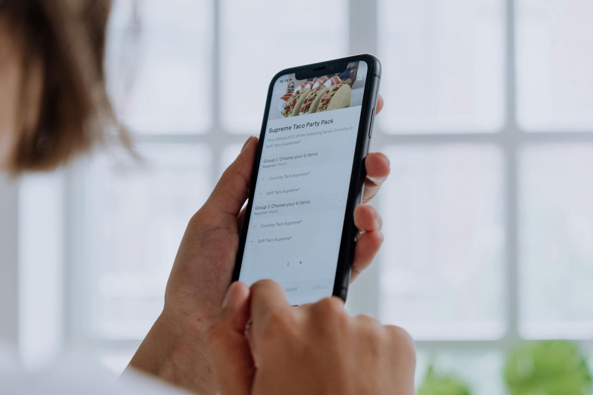 A person is holding a cell phone in their hand.