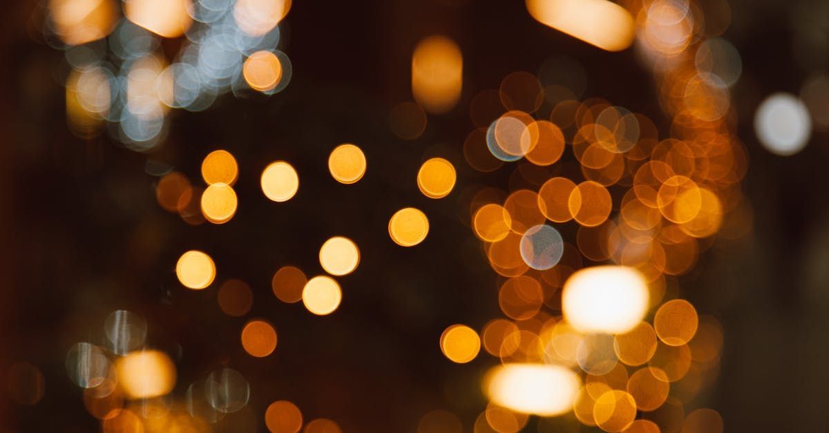 A blurry picture of christmas lights in the dark.