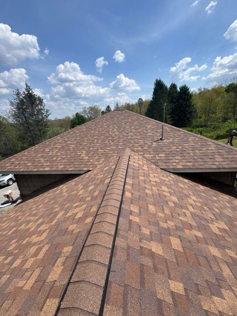 A close up of a roof with a lot of shingles on it.
