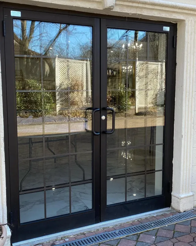 Custom commercial dark aluminum double glass doors with grid styling, installed for a local business entrance by Arsenal Glass in New Jersey.