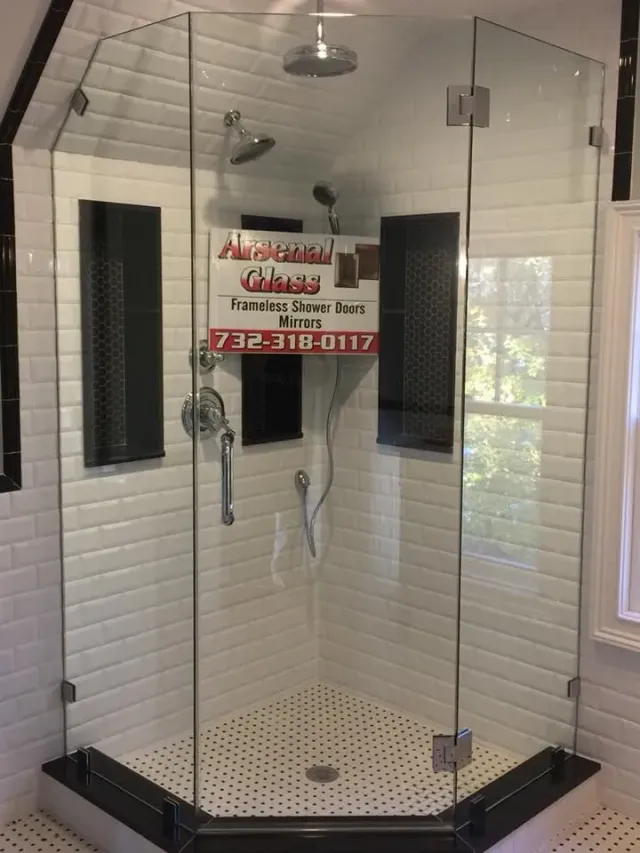 Custom neo-angle frameless glass shower enclosure with an angled ceiling cut and white subway tile, expertly installed by Arsenal Glass in NJ.