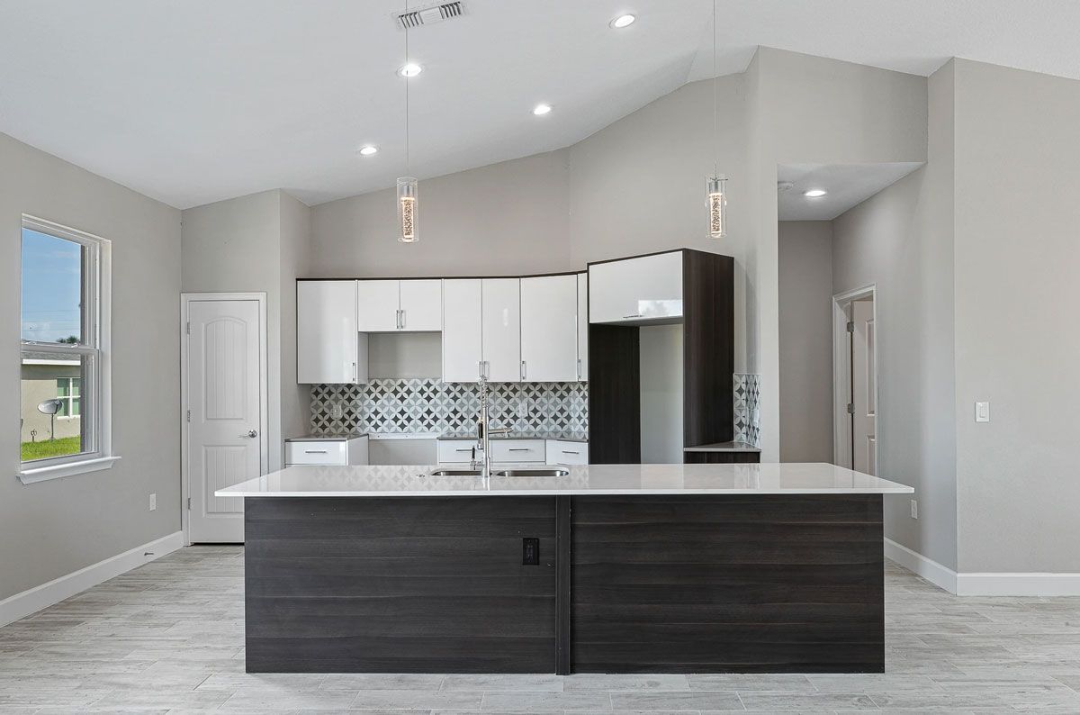 A kitchen with a large island in the middle of the room.