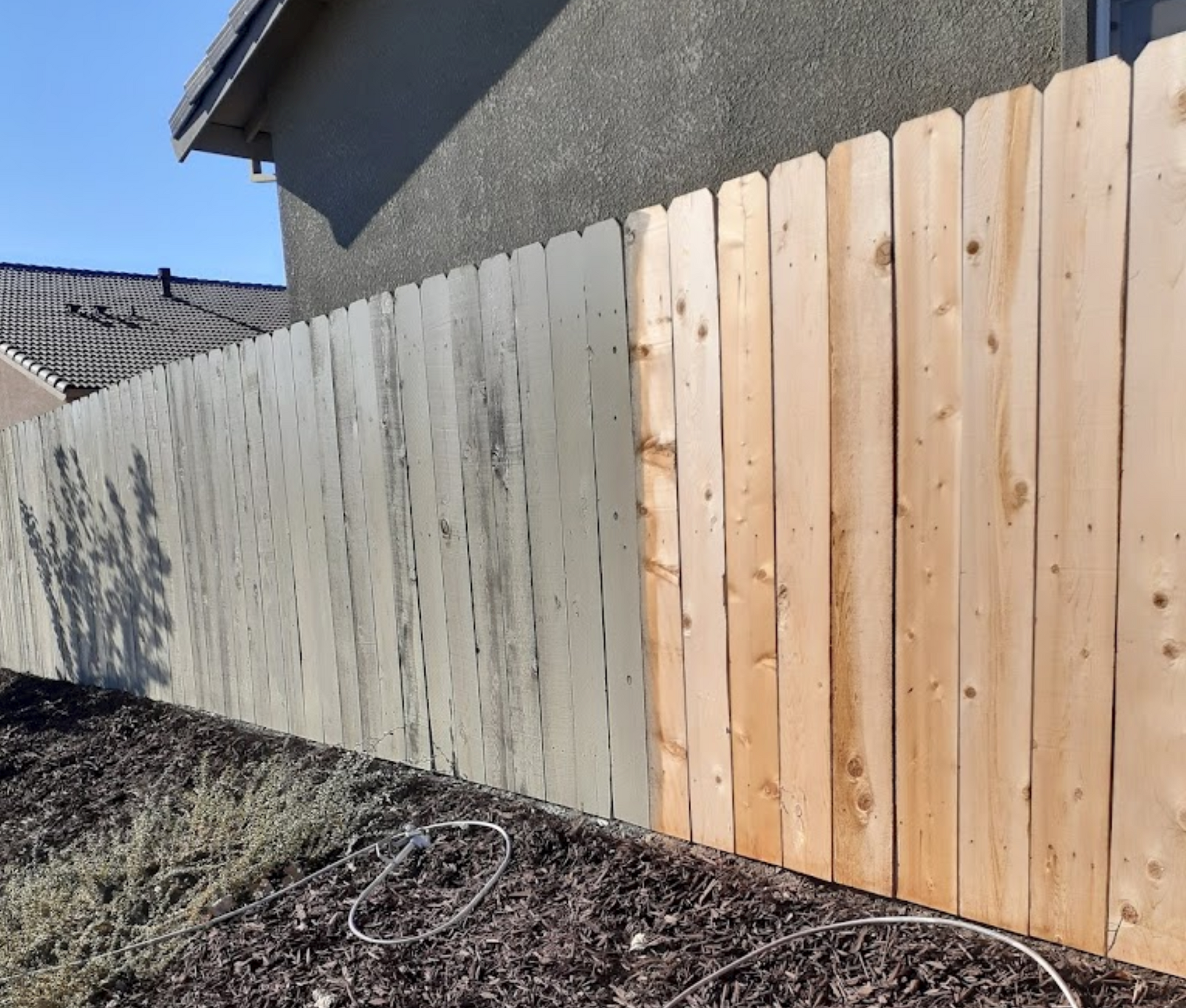 Professional fence painting in progress by Bratts Painting in Manteca.