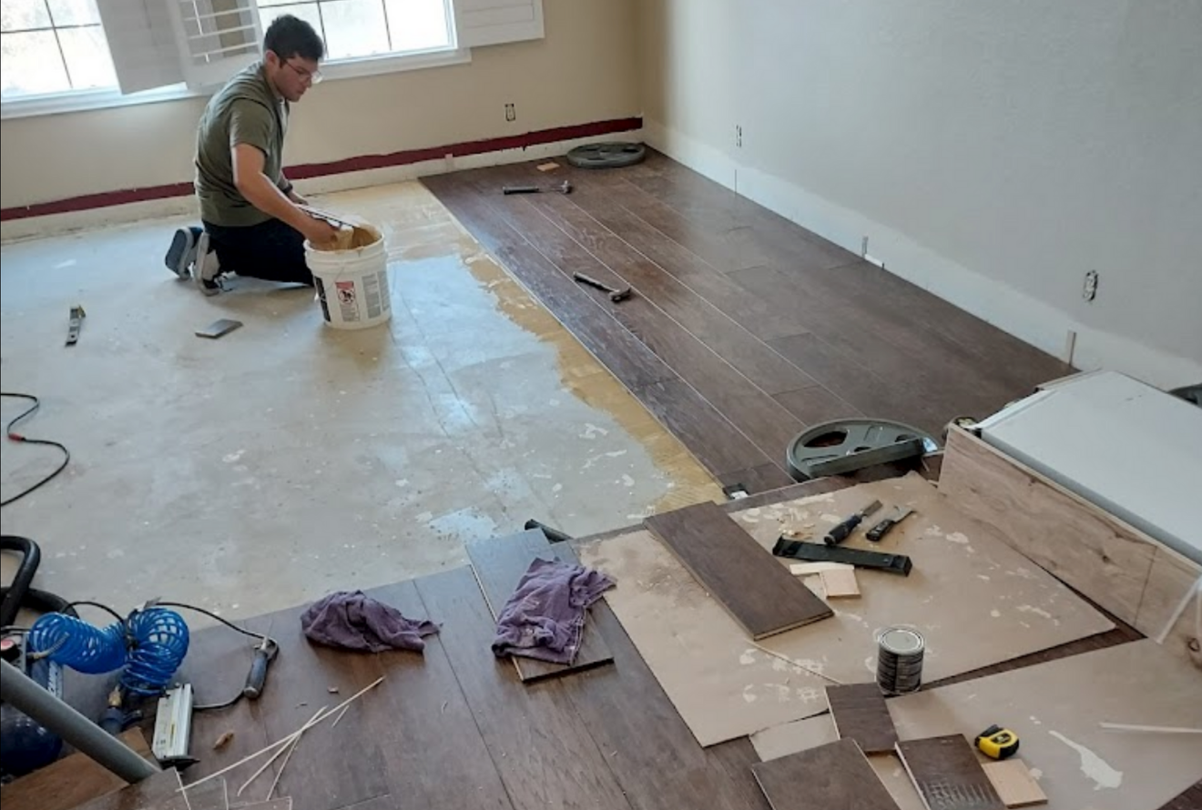 Professional handyman services by Bratt's Painting, repairing woodwork in a home.