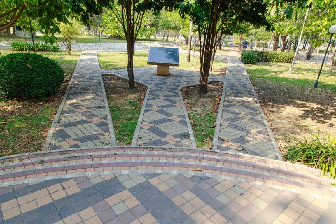 Three stamped concrete walkways leading into a decorated concrete circle