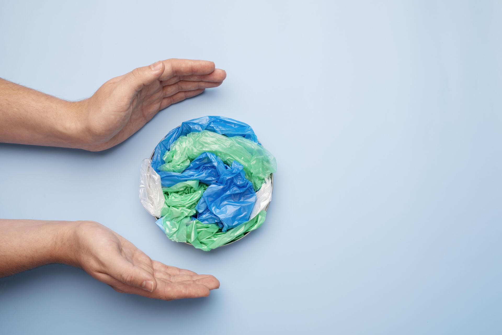 Una persona tiene in mano un globo fatto di sacchetti di plastica