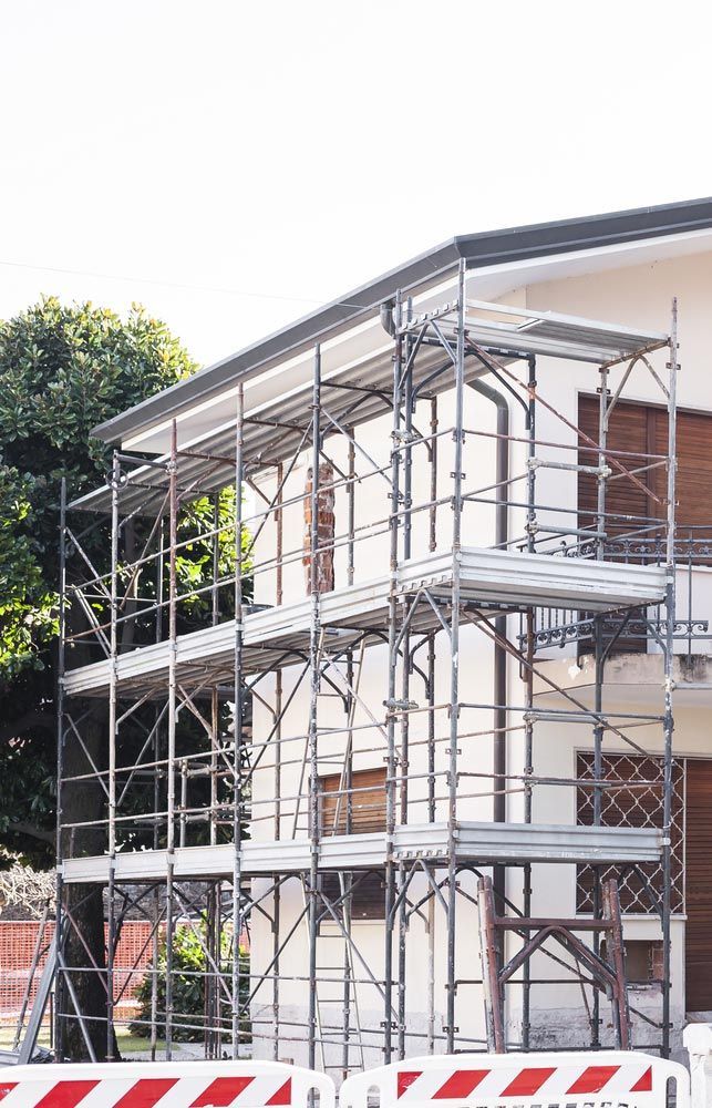 A House Is Being Built With Scaffolding Around It — JD Lynch Constructions in Cannonvale, QLD