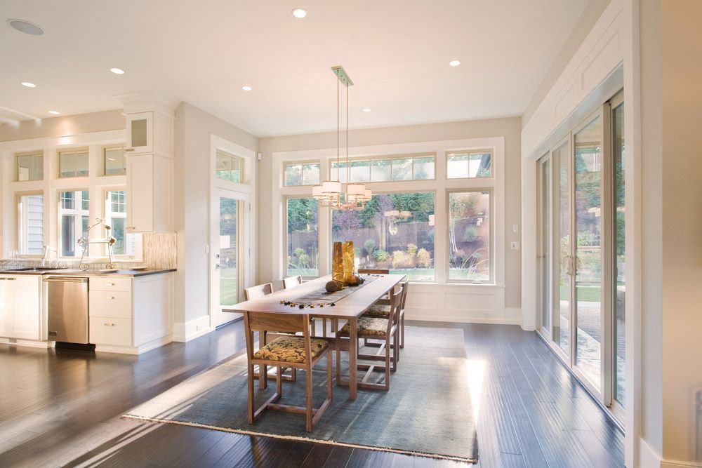 A Dining Room With A Table And Chairs And Lots Of Windows — JD Lynch Constructions in Cannonvale, QLD