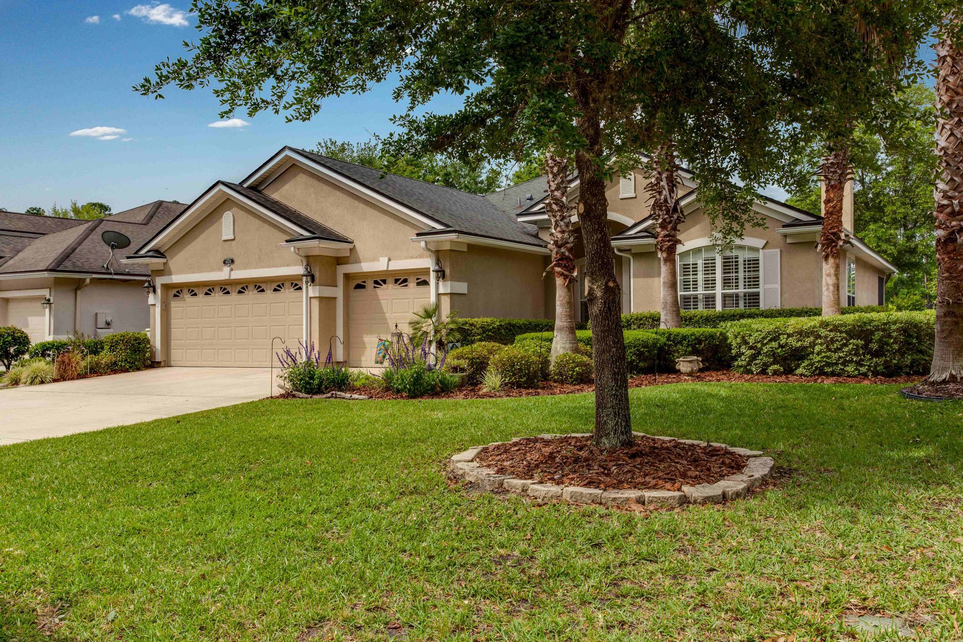 a house with a lot of grass and trees in front of it