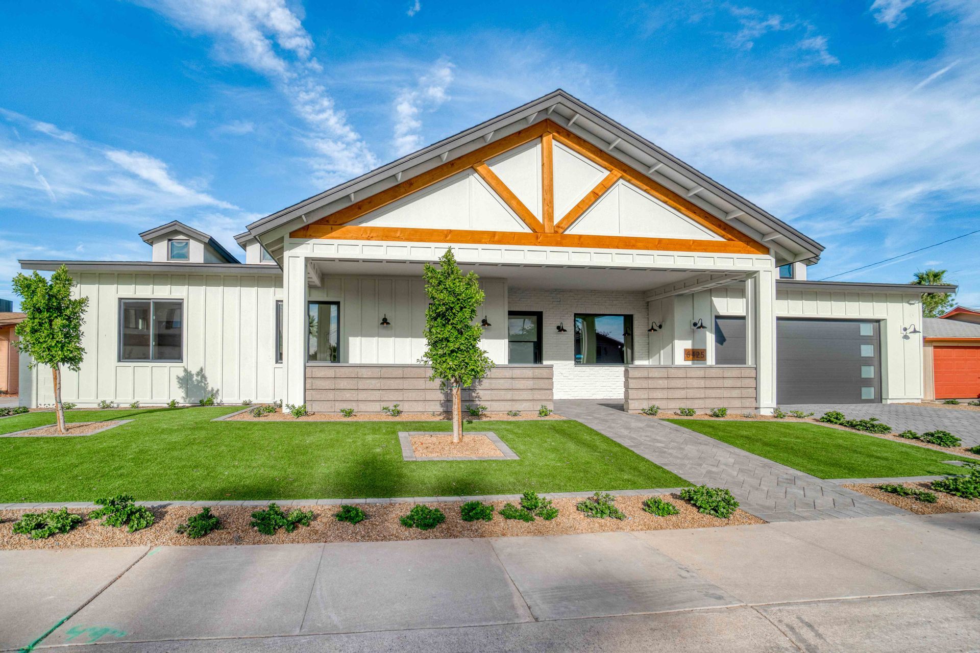 a large white house with a wooden roof is for sale