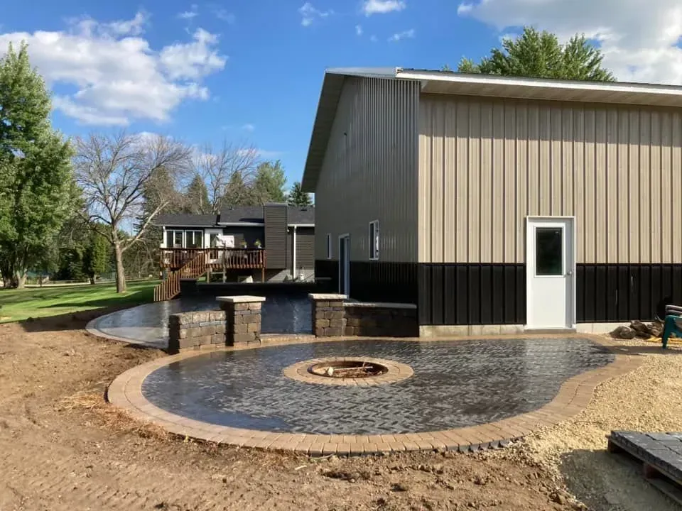 a large metal building with a fire pit in front of it