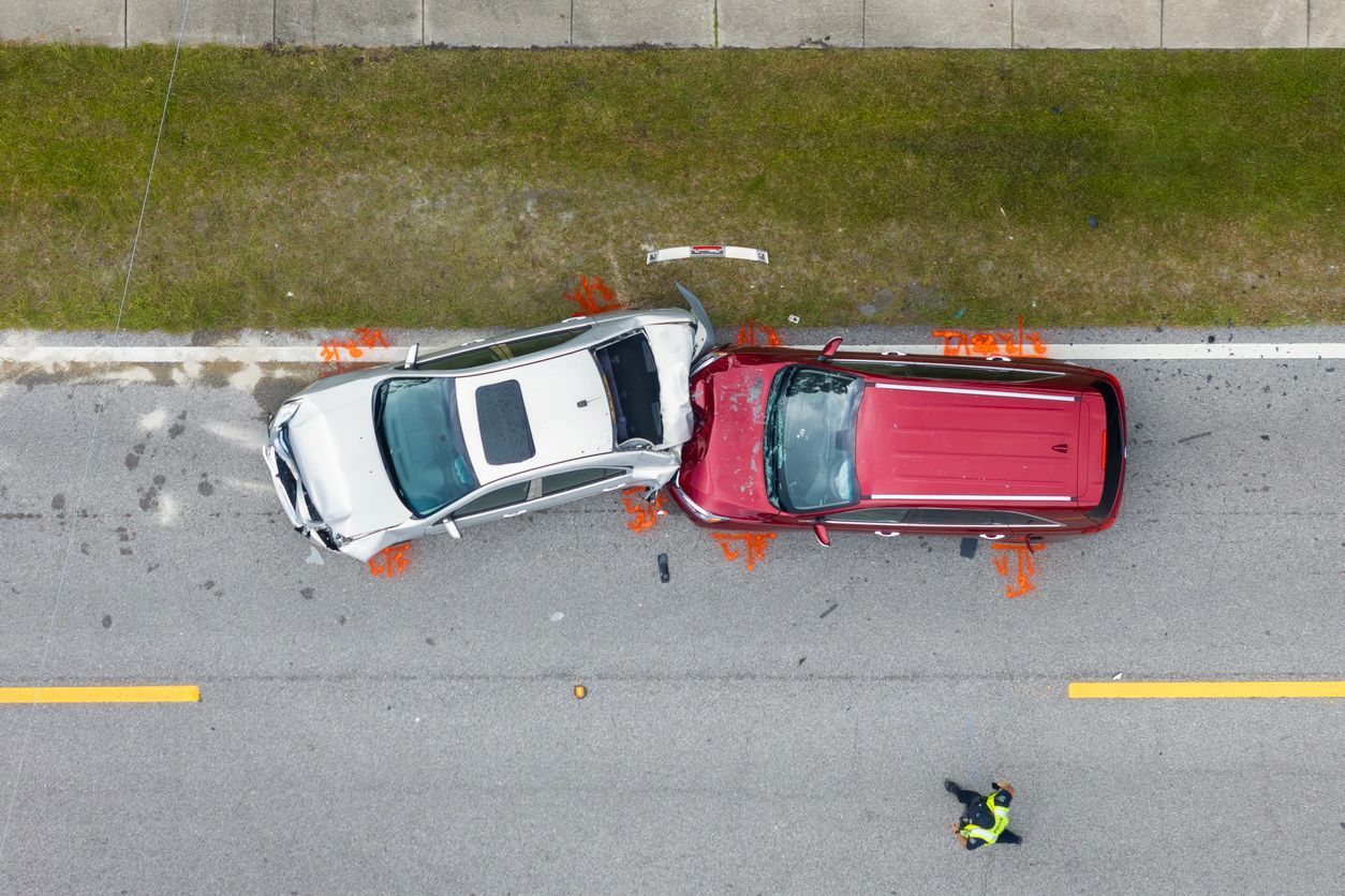 Two cars collided with a police officer inspecting the accident scene