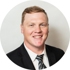 A man in a suit and tie is smiling in a circle