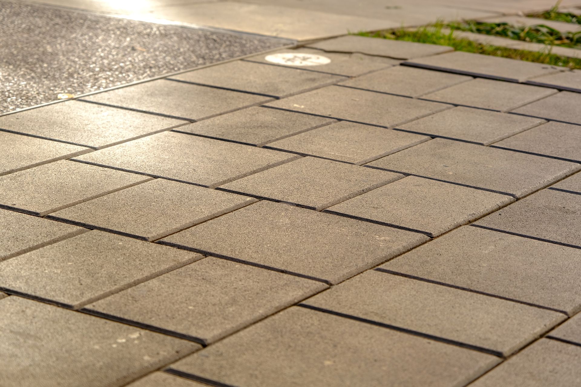 A close up of a sidewalk with bricks on it