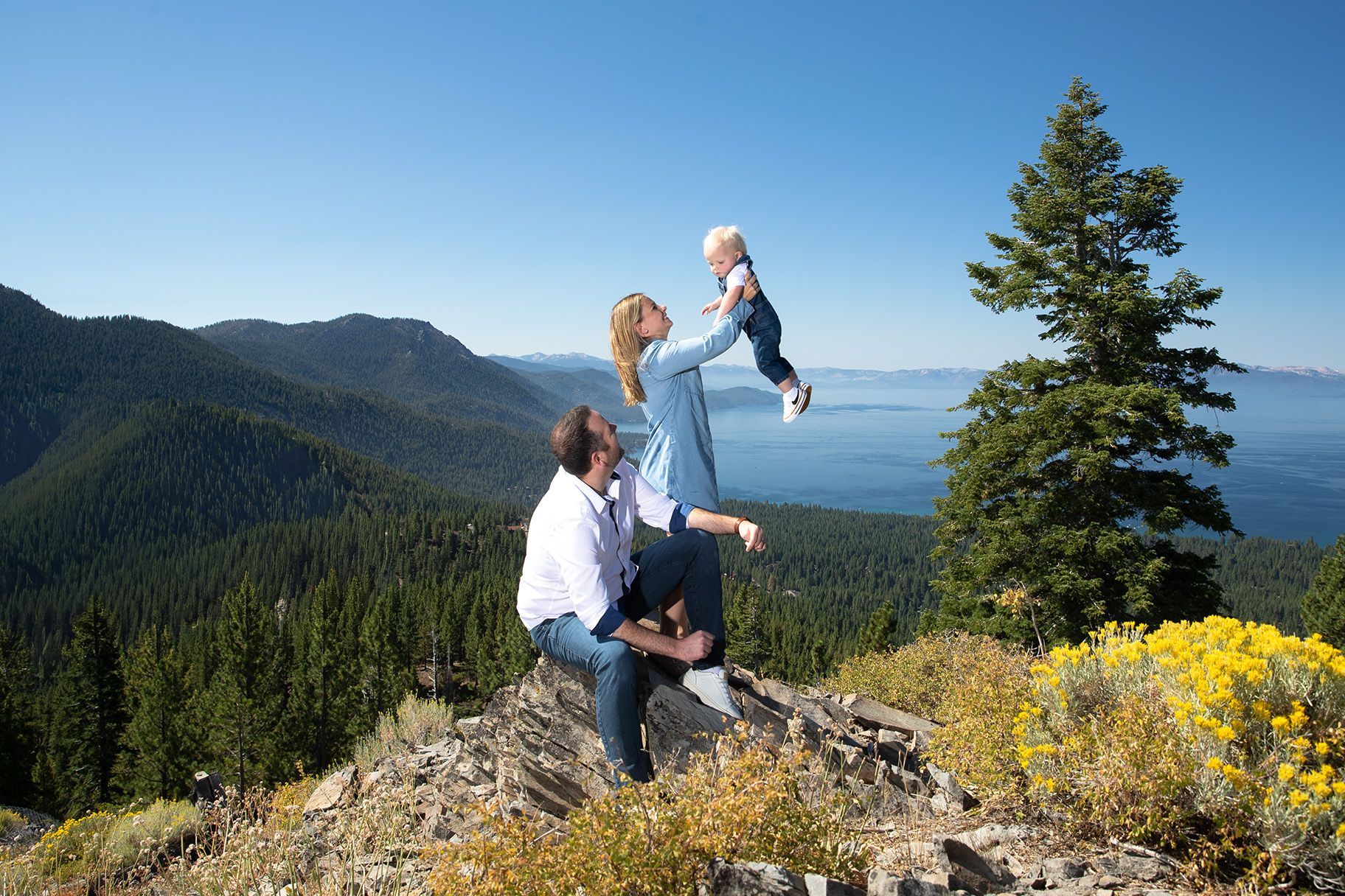 Lake Tahoe family photography with mountains, trees, and clear blue sky