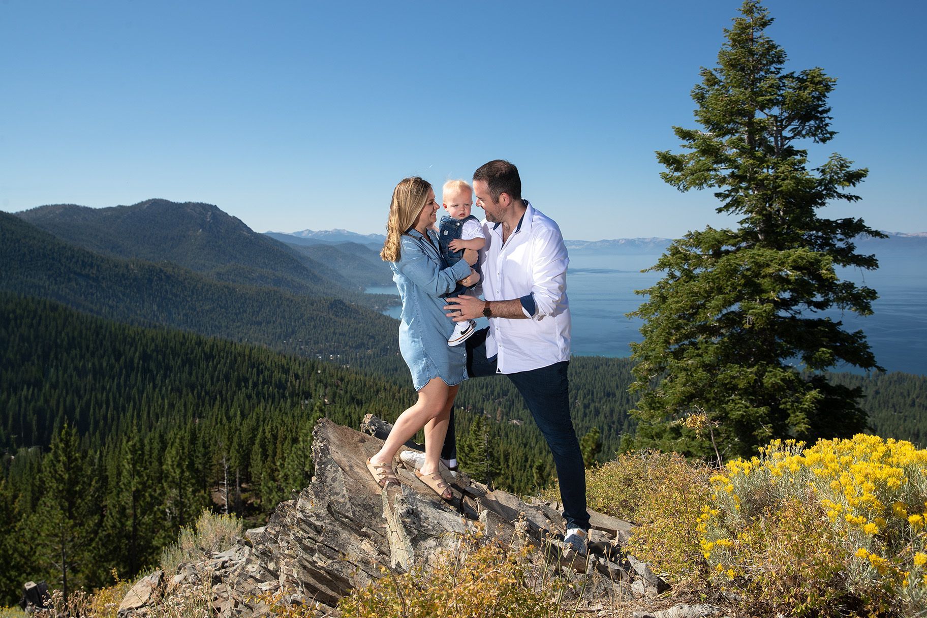 Parents and children laughing together on a mountaintop in North Lake Tahoe