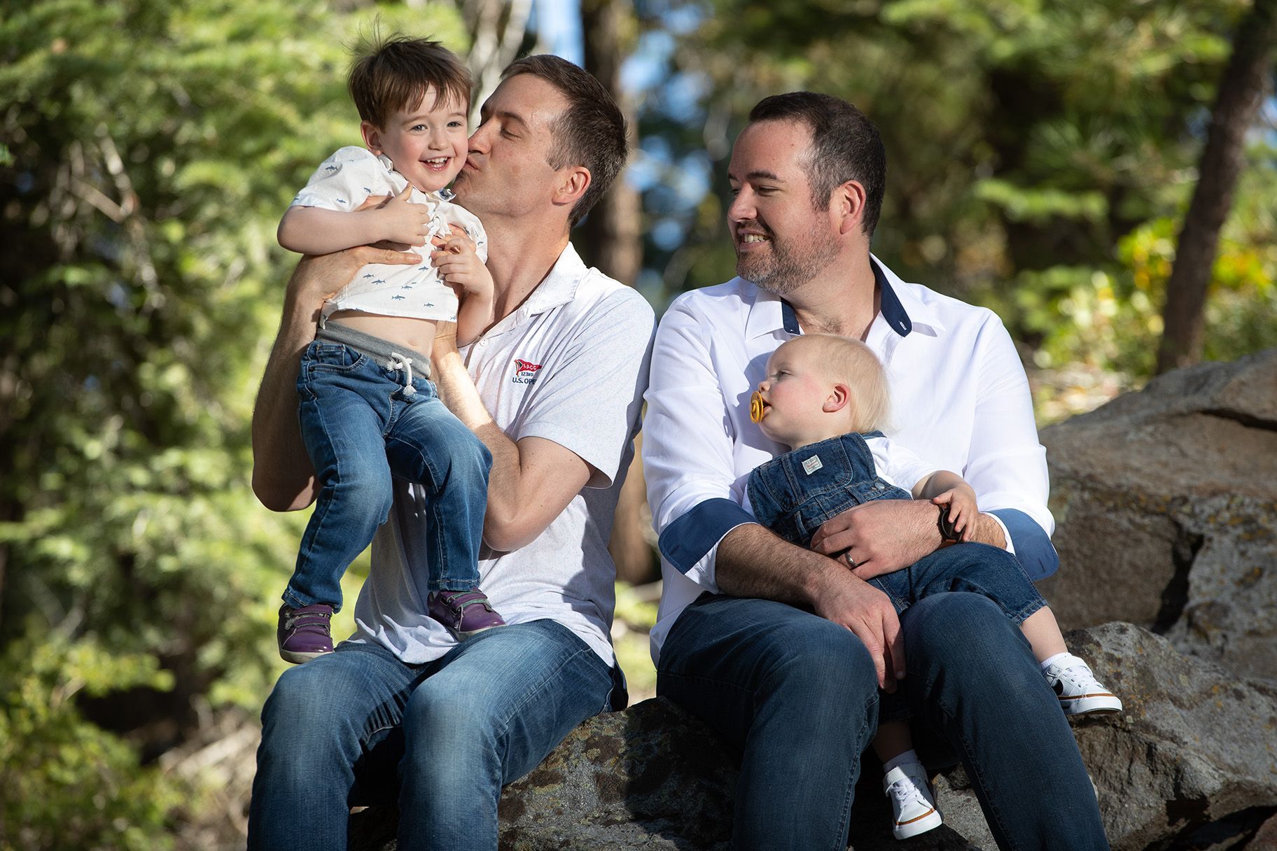 Family sitting on boulders during photography session in Incline Village, Tahoe